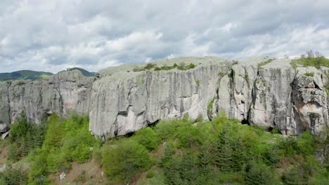 Drone-approaching-the-rock-face-of-Belintash-Plateau-situated-in-Rhodope-Mountains-in-the-province-of-Plovdiv-in-Bulgaria