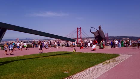 Esplanade-of-the-Cristo-Rei-viewpoint,-with-the-25-de-Abril-Bridge-in-the-background,-Lisbon,-Portugal