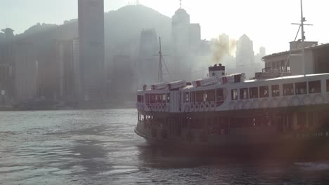 Ferry-ships-passing-through-the-iconic-Tsim-Sha-Tsui-promenade,-Hong-Kong,-China