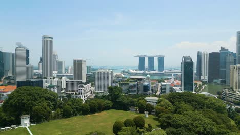 drone-ascending-over-Singapore,-rising-establishment-shot-of-Singaporean-skyline-and-seaview