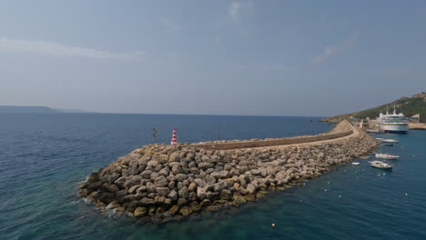Mgarr-port-lighthouse-and-breakwater,-aerial-drone-view