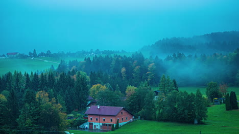 Misty-morning-in-the-Austrian-Alps-with-a-red-roofed-house-among-trees-near-near-the-Attersee