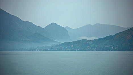 Timelapse-of-clouds-gathering-at-mountain-base-in-Attersee-Austria-over-lake