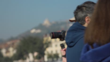 Professional-cameraman-recording-video-while-walking-in-Verona-city-in-Italy