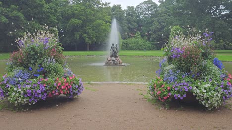 Pond-with-fountain-in-an-urban-park-in-Aalborg,-Denmark