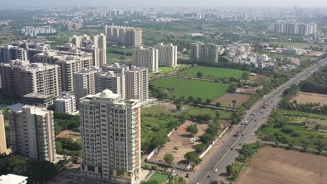 RAJKOT-CITY-AERIAL-VIEW-DRONE-FROM-KALAWAD-ROAD-High-rise-buildings-are-visible-side-by-side,-with-solar-systems-mounted-on-them