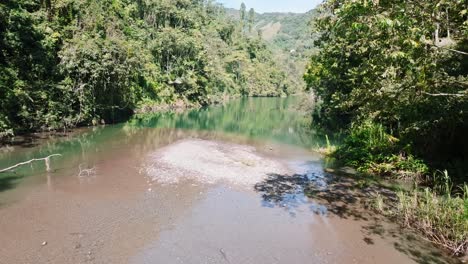 Forward-shot-over-water-at-Tireo-Dam-in-Loma-de-Blanco-Bonao,-Dominican-Republic