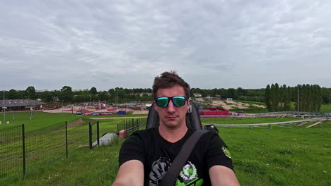 A-Selfie-Shot-Of-A-Man-Admiring-The-Surroundings-As-He-Rides-On-A-Mini-Roller-Coaster-At-A-Park