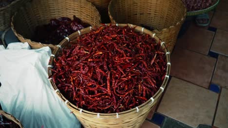 Dry,-Red,-Hot,-Thai-Chili-Peppers-Harvested-And-Dried-In-A-Large-Woven-Basket