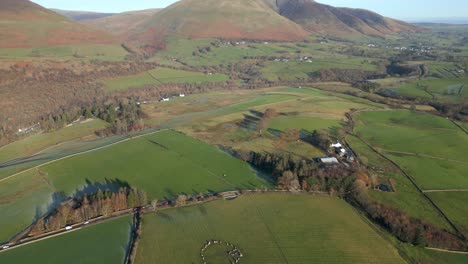 Ancient-stone-circle-from-high-altitude-with-camera-pan-up-revealing-mountain-Blencathra