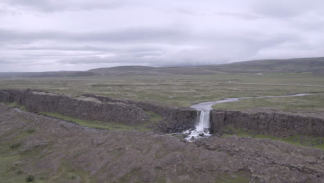 Öxarárfoss-waterfall-in-Iceland-aerial-push-in-over-landscape