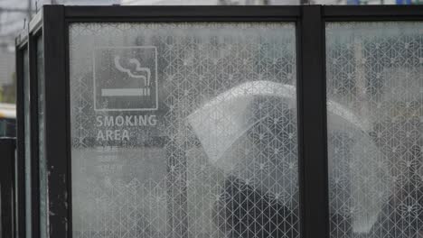 People-Smoking-at-Public-Designated-Smoking-Area-in-the-Street,-Shinjuku,-Tokyo,-Japan