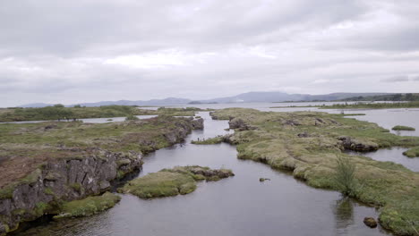 Silfra-Snorkeling-Pond-in-Iceland-aerial-push-in-over-the-water