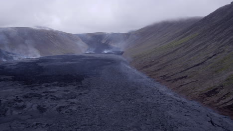 Fagradalsfjall-volcano-in-Iceland-lower-aerial-tracking-shot-from-right-to-left-over-the-cooling-lava