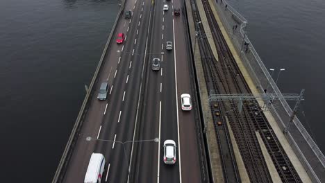 Cinematic-aerial-tilt-up-along-busy-highway-in-Stockholm-reveals-city-center-historic-buildings