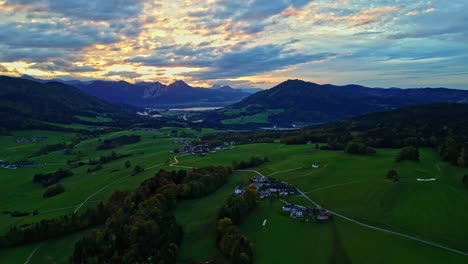 Scenic-aerial-sunset-view-with-vibrant-illuminated-clouds-over-Attersee,-Austria