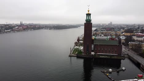 Aerial-pan-across-Stockholm-city-center-with-prominent-tower-and-golden-weather-vane