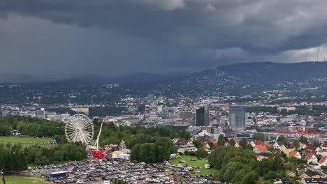 A-close-up-shot-from-a-drone-shows-the-Ferris-wheel-and-the-Tivoli-at-Ekebergsletta-during-the-Norway-Cup-2023-with-the-center-of-Oslo-in-the-background