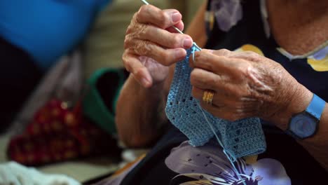 Aged-woman-doing-crochet,-needlecraft-making-at-home