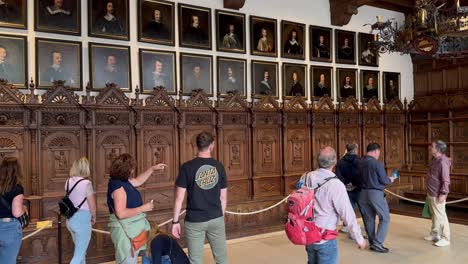 Tourist-visiting-old-historic-room-of-townhall-in-Muenster-City,-Germany---Peace-of-Westphalia-1648-Friedenssaal-The-Hall-of-Peace