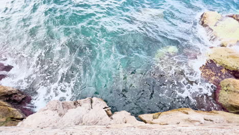 Clear-sea-water-crashing-against-rocky-shore