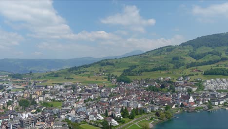 Kussnacht-Flyover:-Moving-Over-Scenic-Water-Valley-and-Village-in-Alps-Mountains,-Switzerland,-Europe,-Drone-|-Dramatic-Cinematic-Flyover-of-Homes-in-Village-City-Along-Vast-Lake-and-Countryside