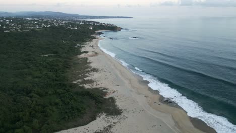 drone-approaching-tropical-sand-ocean-beach-in-Mexico-Oaxaca-Puerto-Escondido