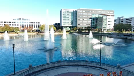 “Love-NN”-sign-in-Newport-News’-City-Center,-with-office-buildings-and-a-small-lake-with-fountains-in-the-background
