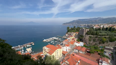 Aerial-view-of-a-quaint-marine-town-by-the-clear-blue-sea---Sorento,-Italy