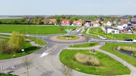 Ein-Kleiner-Kreisverkehr-In-Den-Niederlanden,-Umgeben-Von-Grünen-Feldern-Und-Einer-Stadt-Im-Hintergrund