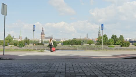 Unrecognisable-Brunette-Woman-with-Red-Suitcase-in-Riga-on-Sunny-Day