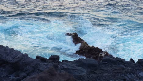 Rocks-being-swallowed-by-waves-of-water-from-the-sea-in-Canary-Island,-Tenerife,-static-slow-motion