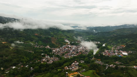Drone-shot-overlooking-the-San-Rafael-village-in-middle-of-clouds-of-Colombia