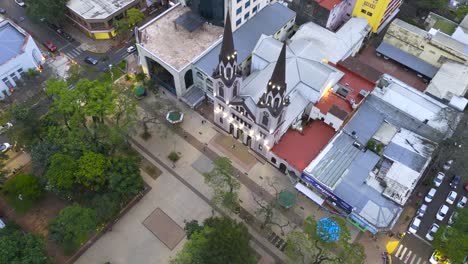 Top-down-aerial-view-of-the-San-Jose-cathedral-and-surrounding-park-and-streets,-urban-city-landscape