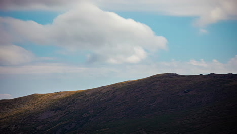 Time-lapse-empty-hill-moving-clouds-shadow-with-blue-sky