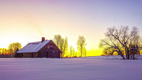 Timelapse-of-a-beautiful-sunrise-with-a-cabin-in-the-snowy-countryside