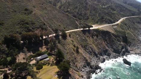 Drone,-Aerial,-and-cinematic-shots-of-the-Big-Sur-coastline-with-unrecognizable-vehicles-running-along-the-road