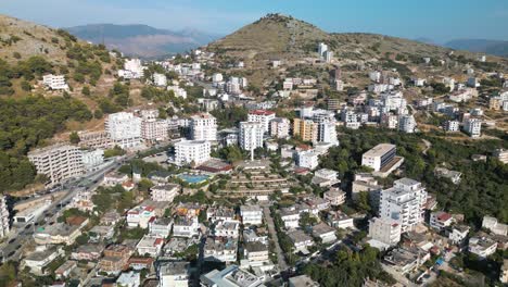 High-Aerial-View-Above-Martyrs-Cemetery,-Mother-Albania-Statue-in-Saranda
