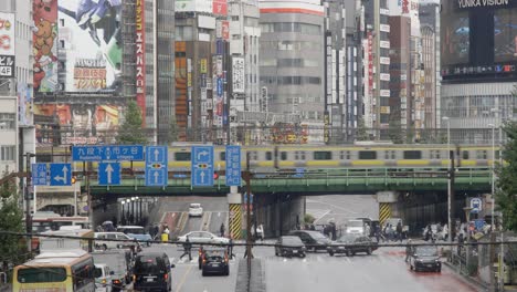 City-Centre-Road-Traffic-and-Commuters,-Shinjuku,-Tokyo,-Japan