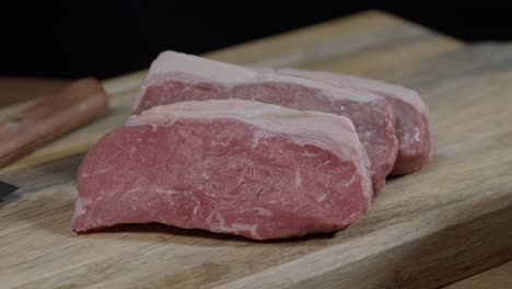 New-York-cuts,-boneless-meat-on-the-wooden-board-after-cutting