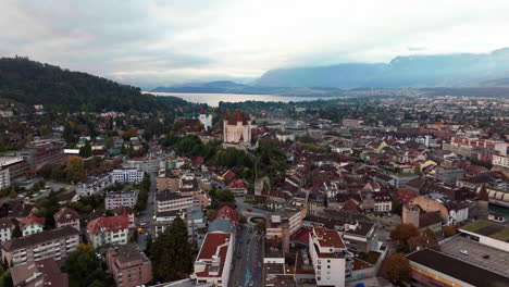 Aerial-cinematic-drone-downtown-Thun-Switzerland-lake-cars-Swiss-village-city-downtown-stunning-Thun-Castle-Dukes-of-Zährigen-Interlocken-Bern-Jungfrau-cloudy-sunrise-sunset-backward-slowly-movement