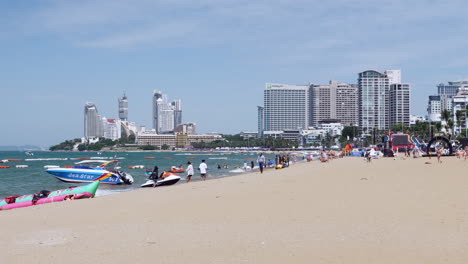 Strandstadt,-Pattaya,-Voller-Touristen-Aus-Verschiedenen-Teilen-Der-Welt,-Die-Während-Dieser-Ferienzeit-Den-Strand-Genießen,-Im-Hintergrund-Sind-Eigentumswohnungen-Und-Hotels-Zu-Sehen,-Thailand