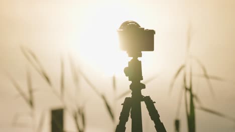 A-professional-camera-on-the-tripod-shooting-sunrise-timelapse
