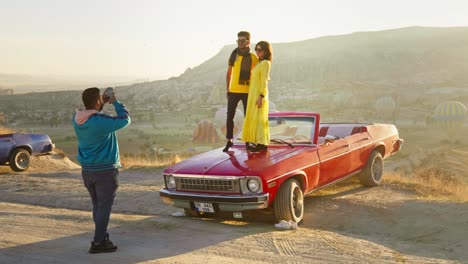 Romantic-couple-sunrise-red-classic-car-photoshoot-epic-landscape