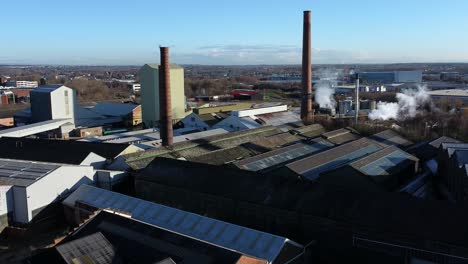 Pilkington-glass-factory-warehouse-buildings-aerial-view-lowering-to-industrial-town-manufacturing-facility