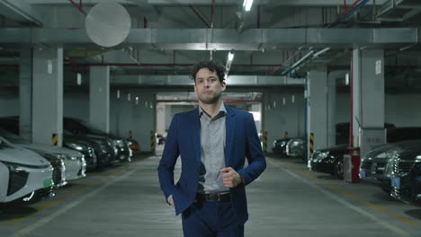 Concept-of-a-confident-businessman-in-a-suit-walking-up-to-the-camera-looking-serious-in-a-parking-garage