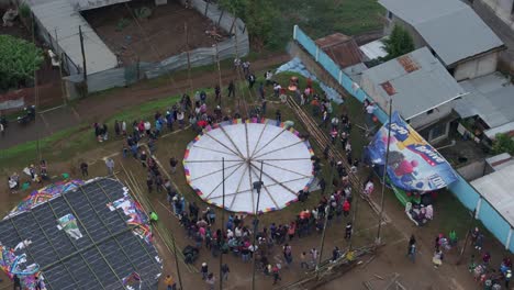 Red-kite-flying-during-All-Saint's-Day-In-Sumpango,-aerial