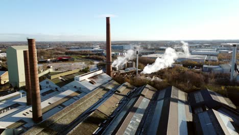 Pilkington-glass-factory-warehouse-buildings-aerial-view-orbiting-industrial-chimney-workshop-skyline