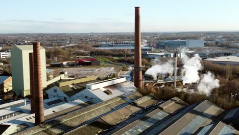 Pilkington-glass-factory-warehouse-buildings-aerial-view-orbiting-industrial-chimney-rooftop