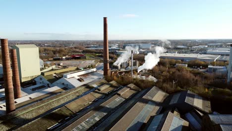 Pilkington-glass-factory-warehouse-buildings-aerial-view-across-industrial-chimney-smokestack-skyline